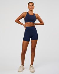 Woman wearing Accelerate Sports Bra - Future Navy | Model:Charlie | Size:XS