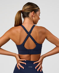 Woman wearing Accelerate Sports Bra - Future Navy | Model:Charlie | Size:XS