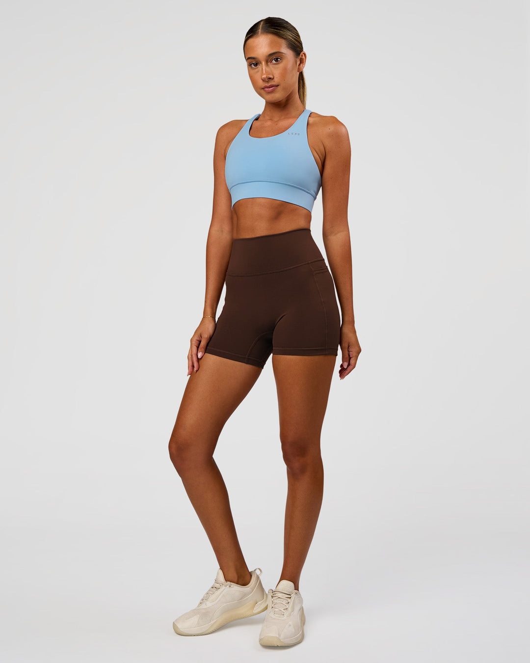 Woman wearing Accelerate Sports Bra - Open Air | Model:Charli | Size:XS