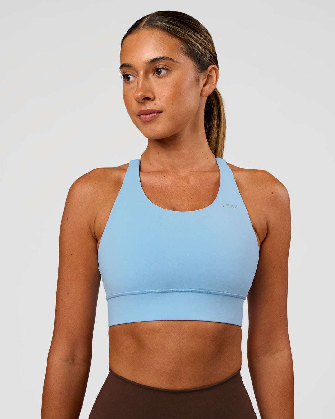 Woman wearing Accelerate Sports Bra - Open Air | Set:true | Angle:front | Model:Charli | Size:XS