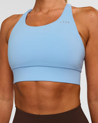 Woman wearing Accelerate Sports Bra - Open Air | Set:true | Angle:closeup | Model:Charli | Size:XS