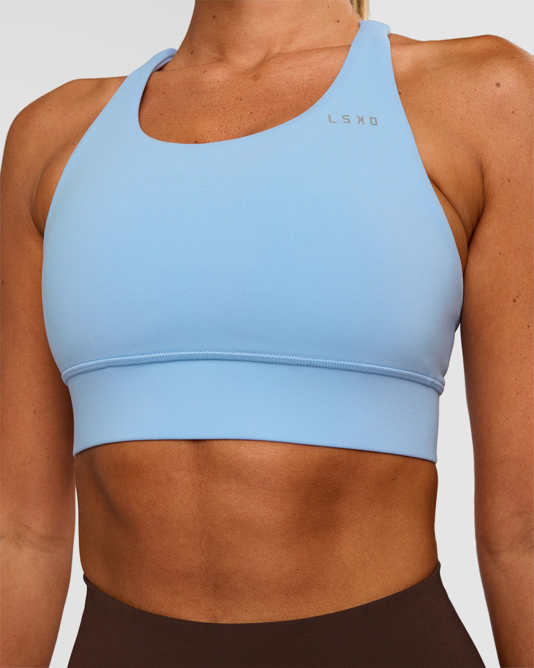 Woman wearing Accelerate Sports Bra - Open Air | Set:true | Angle:closeup | Model:Charli | Size:XS