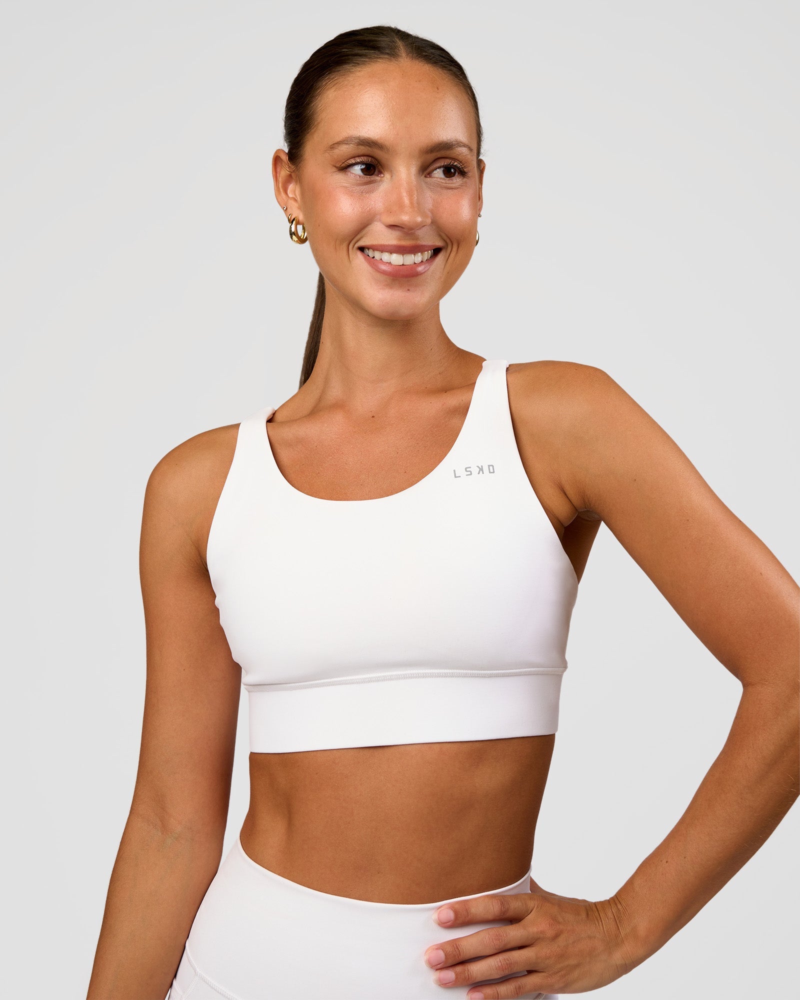 Woman wearing Accelerate Sports Bra - White | Set:true | Angle:front | Model:Brylee | Size:XS