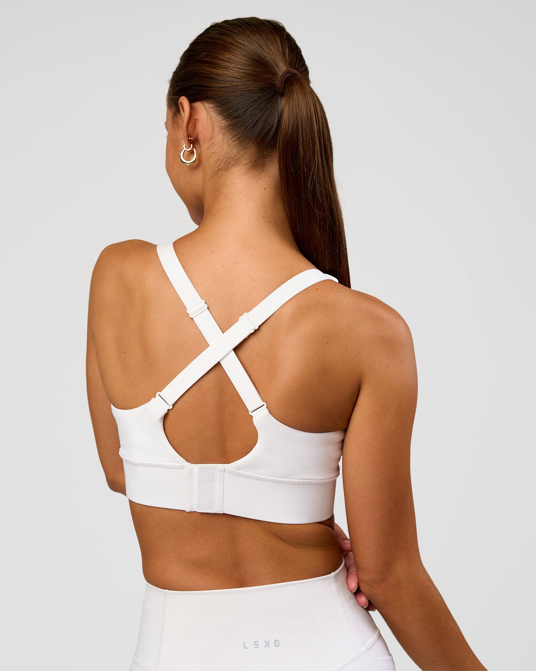 Woman wearing Accelerate Sports Bra - White | Set:true | Angle:back | Model:Brylee | Size:XS - view 2