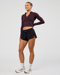 Woman wearing AeroFLX+ Long Sleeve Skimmer Half Zip - Midnight Plum/Midnight Plum | Model:Maja | Size:XS | Thumbnail Index: 2