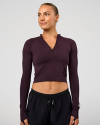 Woman wearing AeroFLX+ Long Sleeve Skimmer Half Zip - Midnight Plum/Midnight Plum | Model:Maja | Size:XS | Thumbnail Index: 0
