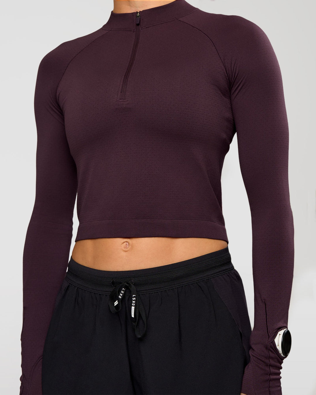 Woman wearing AeroFLX+ Long Sleeve Skimmer Half Zip - Midnight Plum/Midnight Plum | Model:Maja | Size:XS - view 7