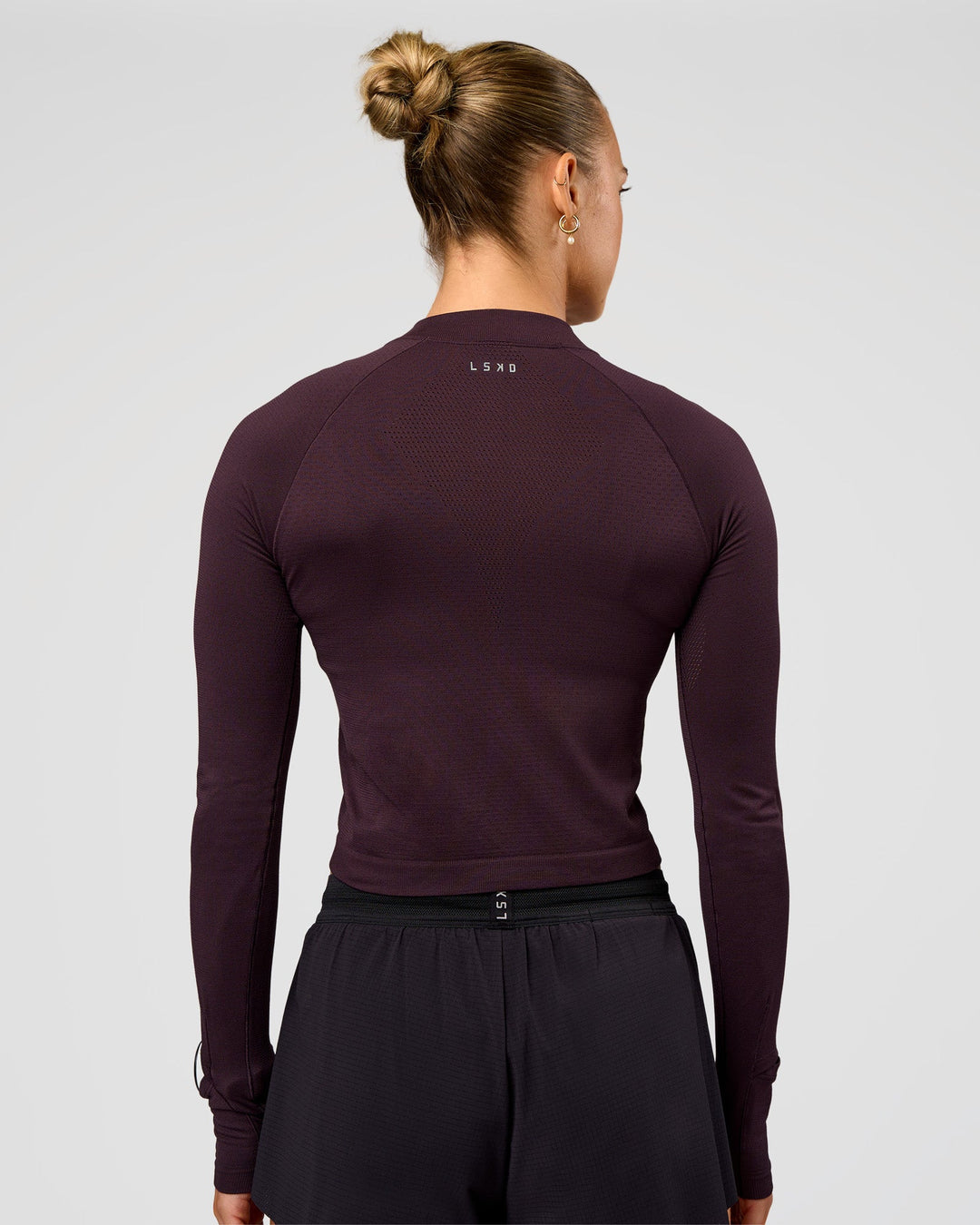 Woman wearing AeroFLX+ Long Sleeve Skimmer Half Zip - Midnight Plum/Midnight Plum | Model:Maja | Size:XS - view 4