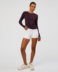 Woman wearing AeroFLX+ Seamless Long Sleeve Tee - Midnight Plum/Midnight Plum | Model:Charli | Size:XS