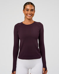 Woman wearing AeroFLX+ Seamless Long Sleeve Tee - Midnight Plum/Midnight Plum | Model:Charli | Size:XS
