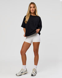 Woman wearing AfterDark ZeroCrease Boxy Tee in Black | Model:Issy | Size:XS