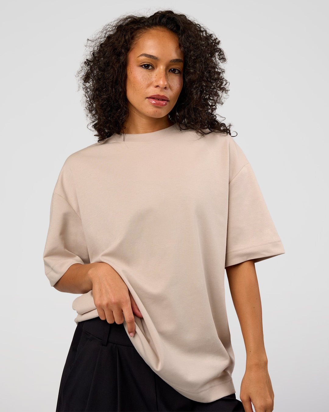 Woman wearing AfterDark ZeroCrease Oversized Tee - Shale Beige | Model:Jasmine | Size:XS - view 4