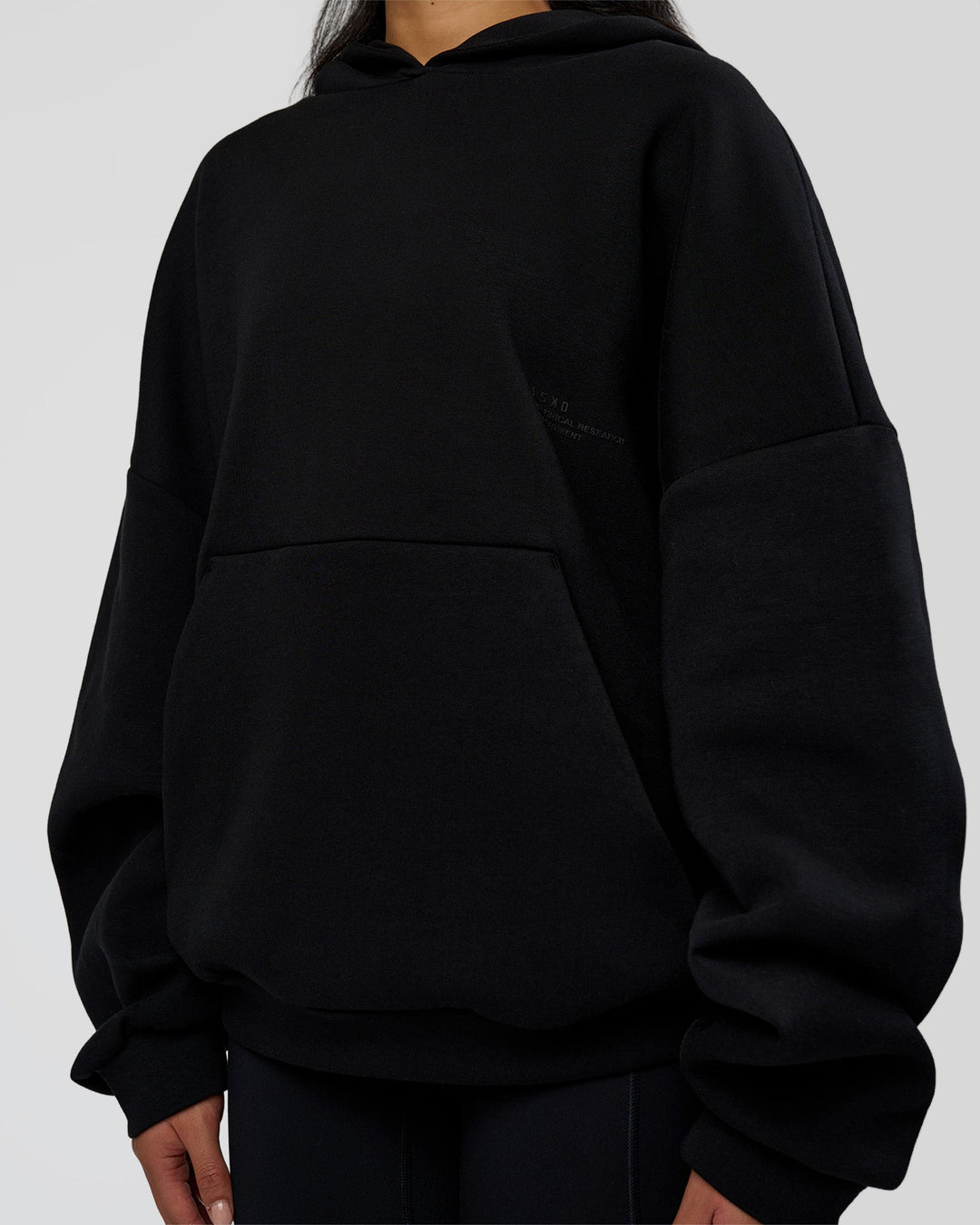 Woman wearing AfterDark ZeroCrease Oversized Hoodie - Black | Model:Loren | Size:XS
