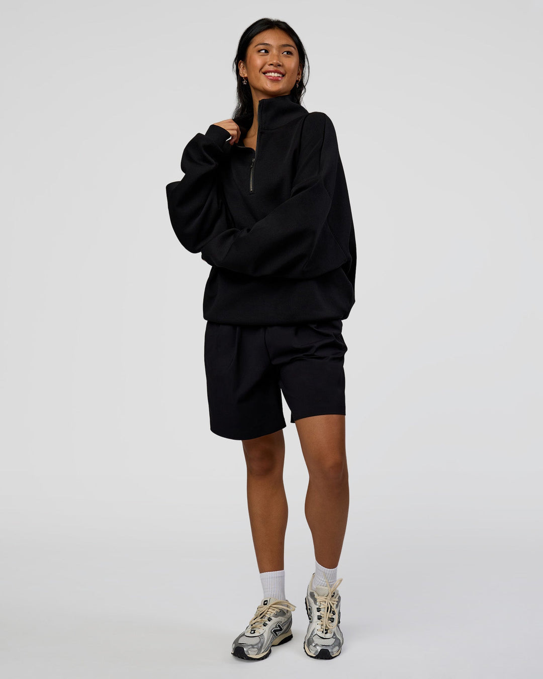 Woman wearing AfterDark ZeroCrease Quarter Zip - Black | Model:Loren | Size:XS
