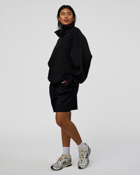 Woman wearing AfterDark ZeroCrease Quarter Zip - Black | Model:Loren | Size:XS