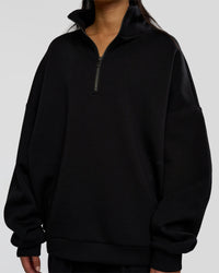 Woman wearing AfterDark ZeroCrease Quarter Zip - Black | Model:Loren | Size:XS