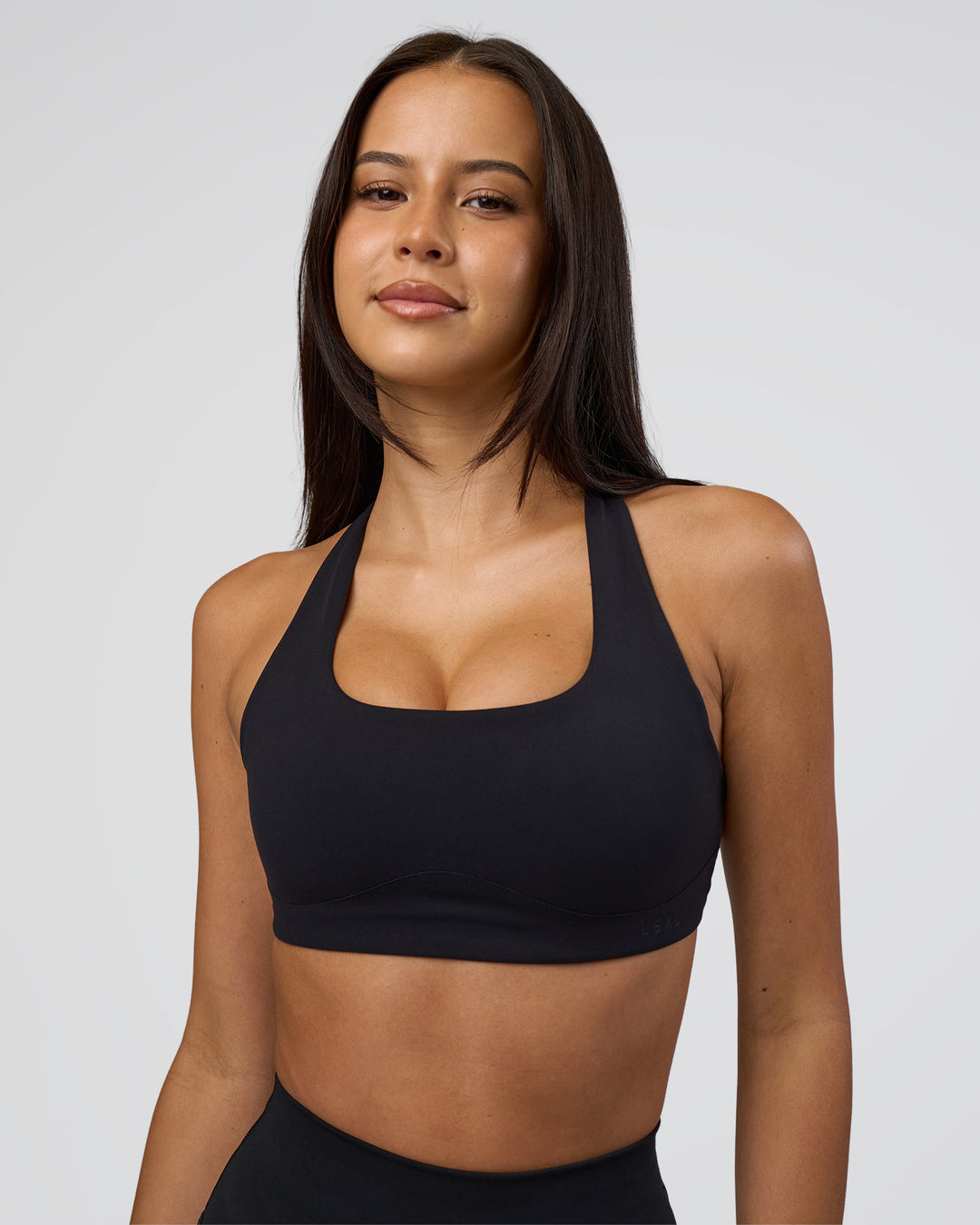 Woman wearing Aspire Sports Bra - Black | Model:Eliza | Size:XS