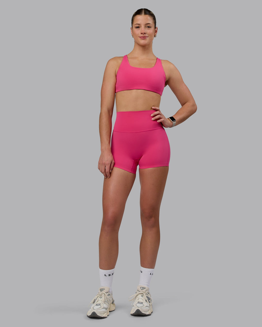 Woman wearing Aspire Sports Bra - Pink Flash