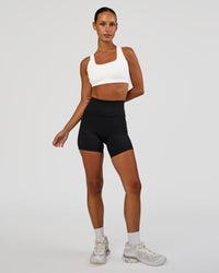Woman wearing Aspire Sports Bra - White | Model:Brylee | Size:XS