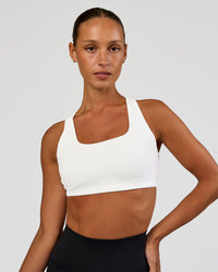 Woman wearing Aspire Sports Bra - White | Model:Brylee | Size:XS