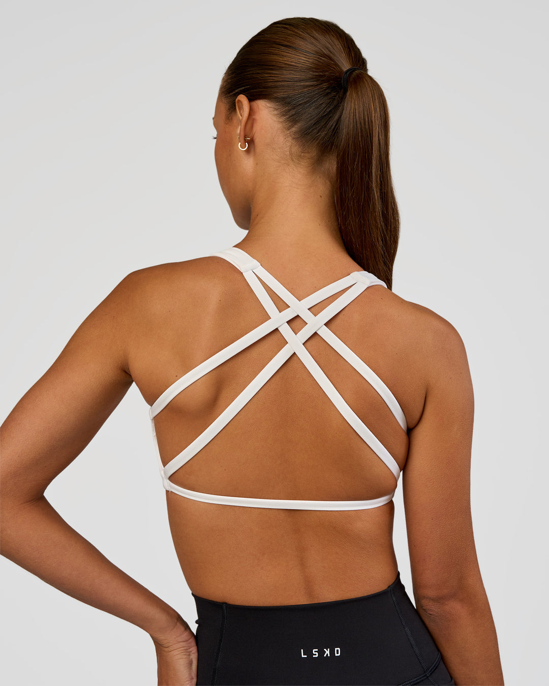 Woman wearing Aspire Sports Bra - White | Model:Brylee | Size:XS