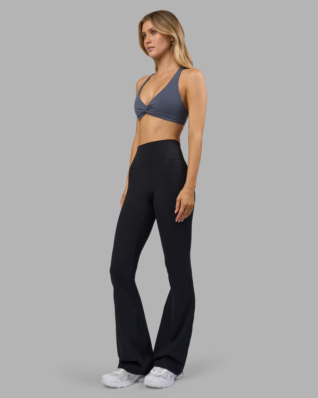 Woman wearing Aspire Twist Sports Bra - Night Shadow | Model:Leilani | Size:XS