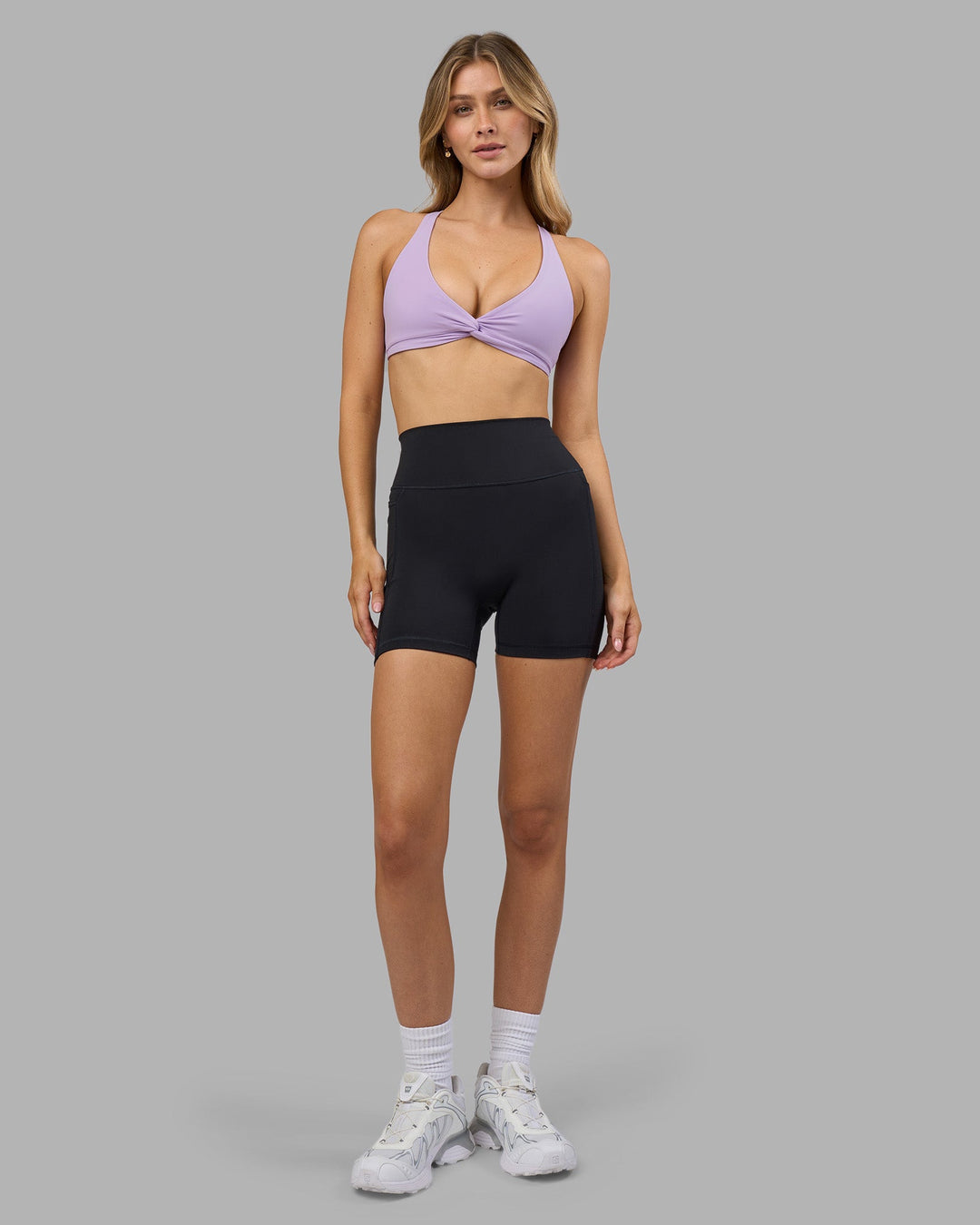 Woman wearing Aspire Twist Sports Bra - Pale Lilac | Model:Leilani | Size:XS