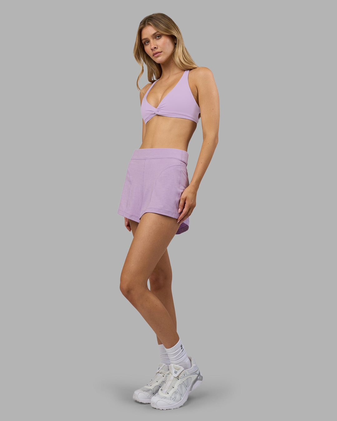 Woman wearing Aspire Twist Sports Bra - Pale Lilac | Model:Leilani | Size:XS