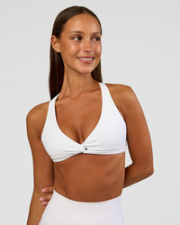 Woman wearing Aspire Twist Sports Bra - White | Model:Brylee | Size:XS | Thumbnail Index: 1