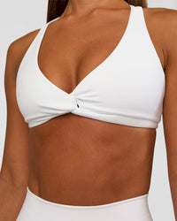 Woman wearing Aspire Twist Sports Bra - White | Model:Brylee | Size:XS | Thumbnail Index: 3
