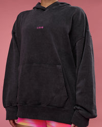 Woman wearing BCAM Washed Unisex Oversized Hoodie - Black Washed-Pink | Model:Hannah | Size:XS