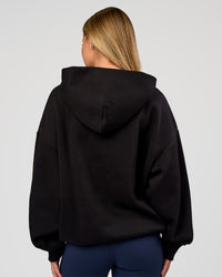 Woman wearing Base Oversized Hoodie - Black | Model:Issy | Size:XS | | Thumbnail Index: 7