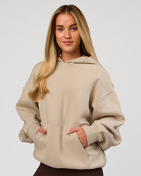 Woman wearing Base Oversized Hoodie - Shale Beige | Model:Issy | Size: XS | | Thumbnail Index: 10