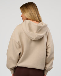 Woman wearing Base Oversized Hoodie - Shale Beige | Model:Issy | Size: XS | | Thumbnail Index: 11