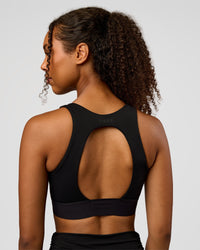 Woman wearing CF Train Hard Sports Bra - Black | Model:Jordan | Size:XS