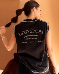 Woman wearing CF Unisex Oversized Heavyweight Boxed Tank - Black-CF X LSKD Sport | Model:Chloe | Size:XS