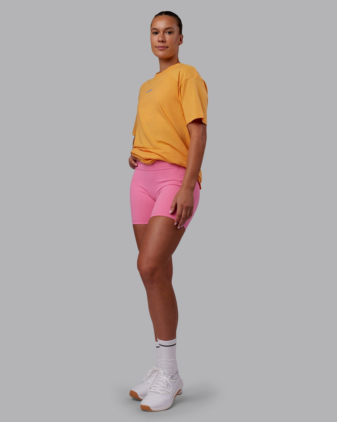 Woman wearing CFT BNE 25 FLXCotton Oversized Tee - Warm Apricot-Purple Opulence | Model:Charlize | Size:XS