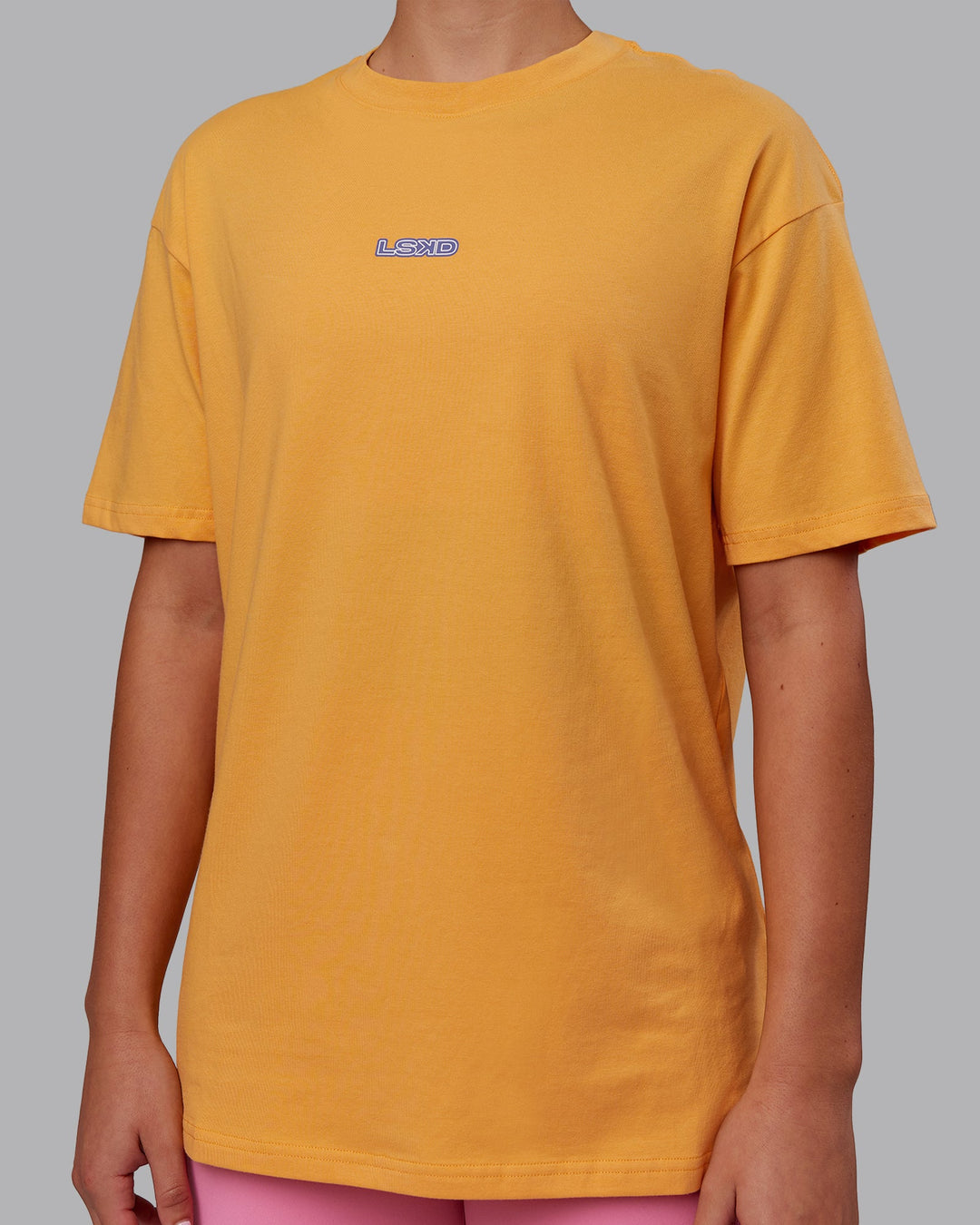 Woman wearing CFT BNE 25 FLXCotton Oversized Tee - Warm Apricot-Purple Opulence | Model:Charlize | Size:XS