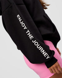 Woman wearing CFT BNE 26 Unisex Oversized Hoodie - Black-Candy Pink | Model:Brylee | Size:XS