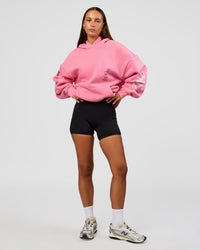 Woman wearing CFT BNE 26 Unisex Oversized Hoodie - Candy Pink-Black | Model:Brylee | Size:XS