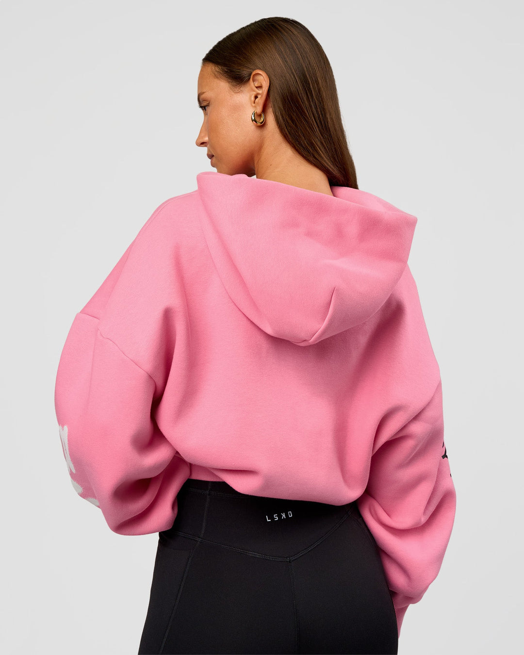 Woman wearing CFT BNE 26 Unisex Oversized Hoodie - Candy Pink-Black | Model:Brylee | Size:XS