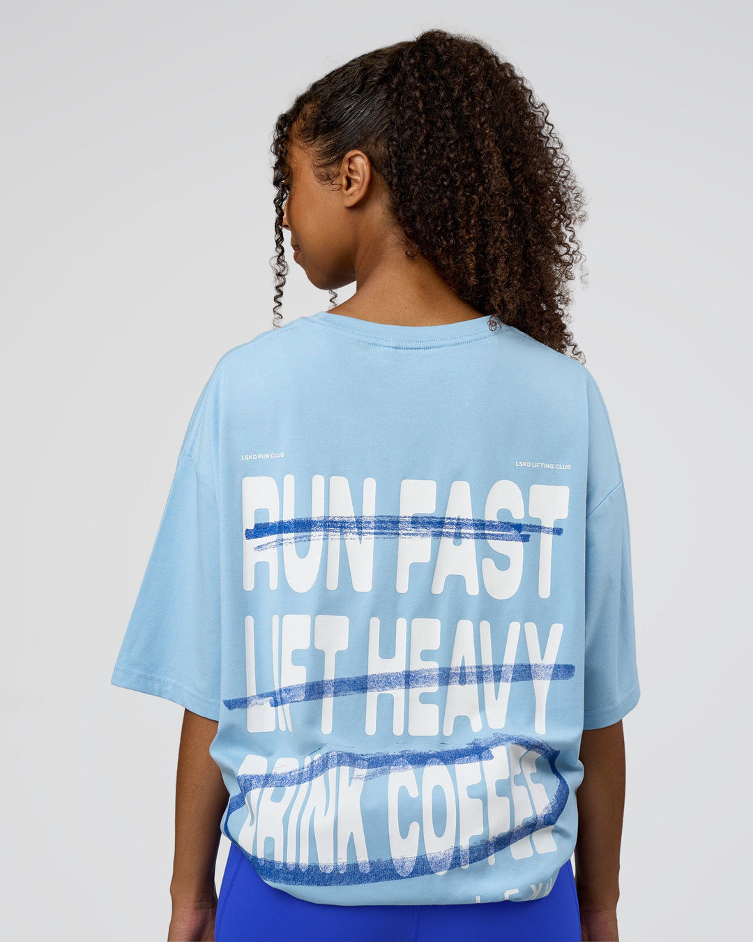 Woman wearing Coffee Run FLXCotton Oversized Tee - Open Air-White | Model:Jordan | Size:XS