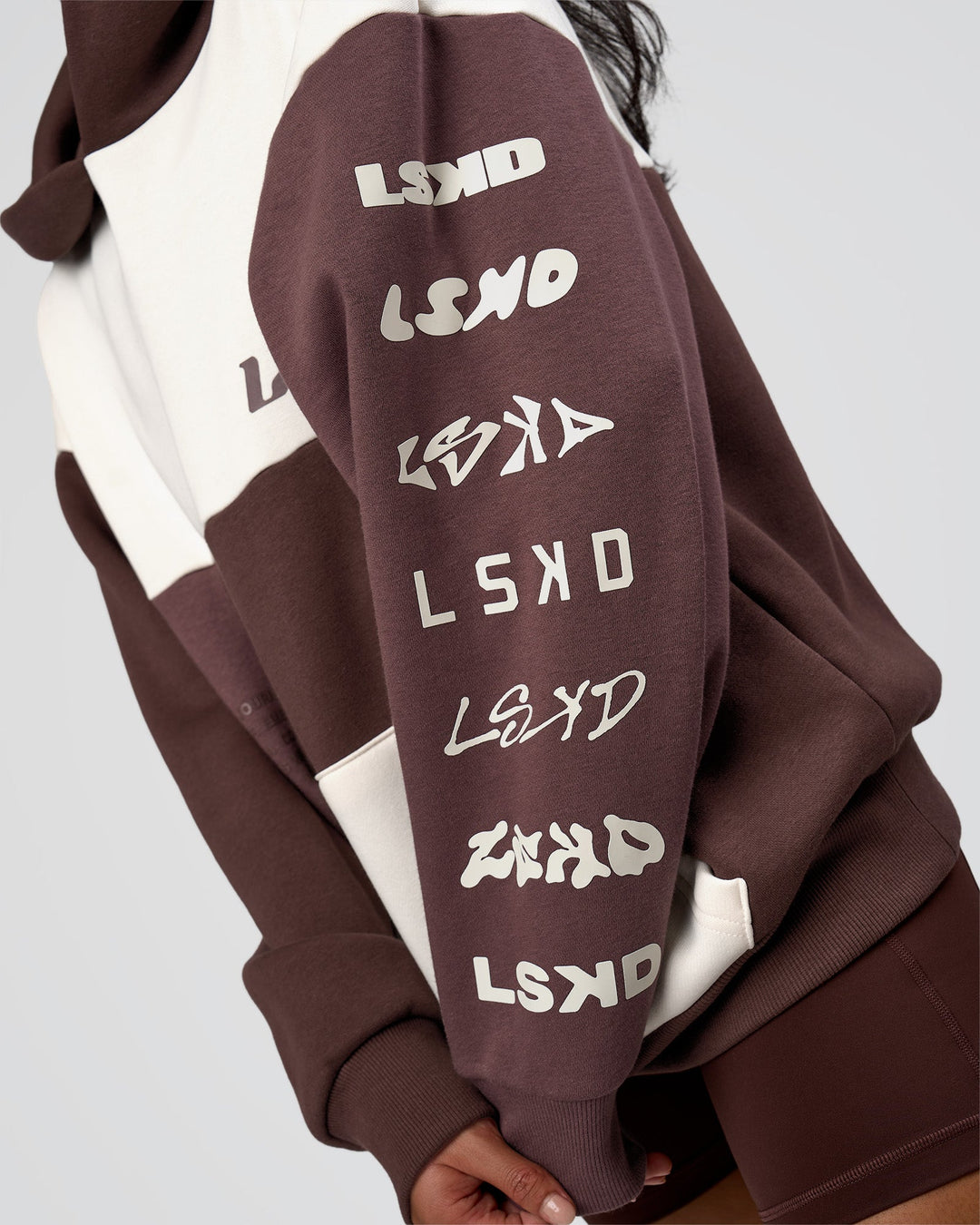 Woman wearing Deconstructed Fleece Hoodie - Off White-Cocoa Powder-Choc | Model:Loren | Size:XS