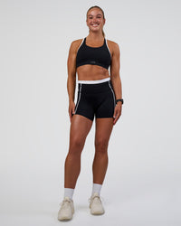 Woman wearing Distinction Sports Bra 2.0 - Black-White | Model:Sav | Size:XS
