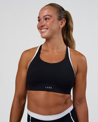 Woman wearing Distinction Sports Bra 2.0 - Black-White | Model:Sav | Size:XS