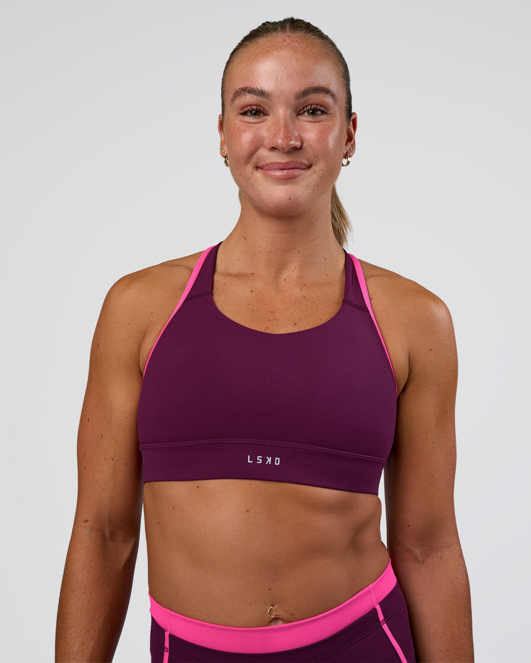 Woman wearing Distinction Sports Bra 2.0 - Plum Caspia-Ultra Pink | Model:Sav | Size:XS