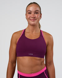 Woman wearing Distinction Sports Bra 2.0 - Plum Caspia-Ultra Pink | Model:Sav | Size:XS