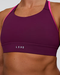Woman wearing Distinction Sports Bra 2.0 - Plum Caspia-Ultra Pink | Model:Sav | Size:XS