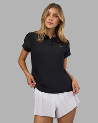 Woman wearing Drive Polo - Black | Model:Leilani| Size:XS | Thumbnail Index: 4