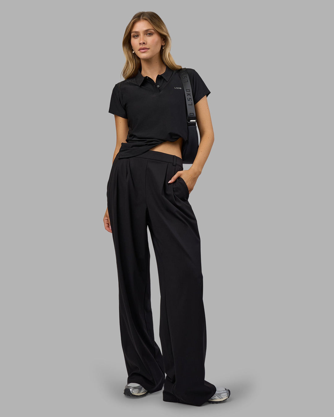 Woman wearing Drive Polo - Black | Model:Leilani| Size:XS